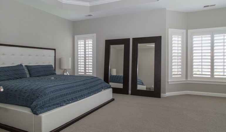 Polywood shutters in a minimalist bedroom in Bluff City.